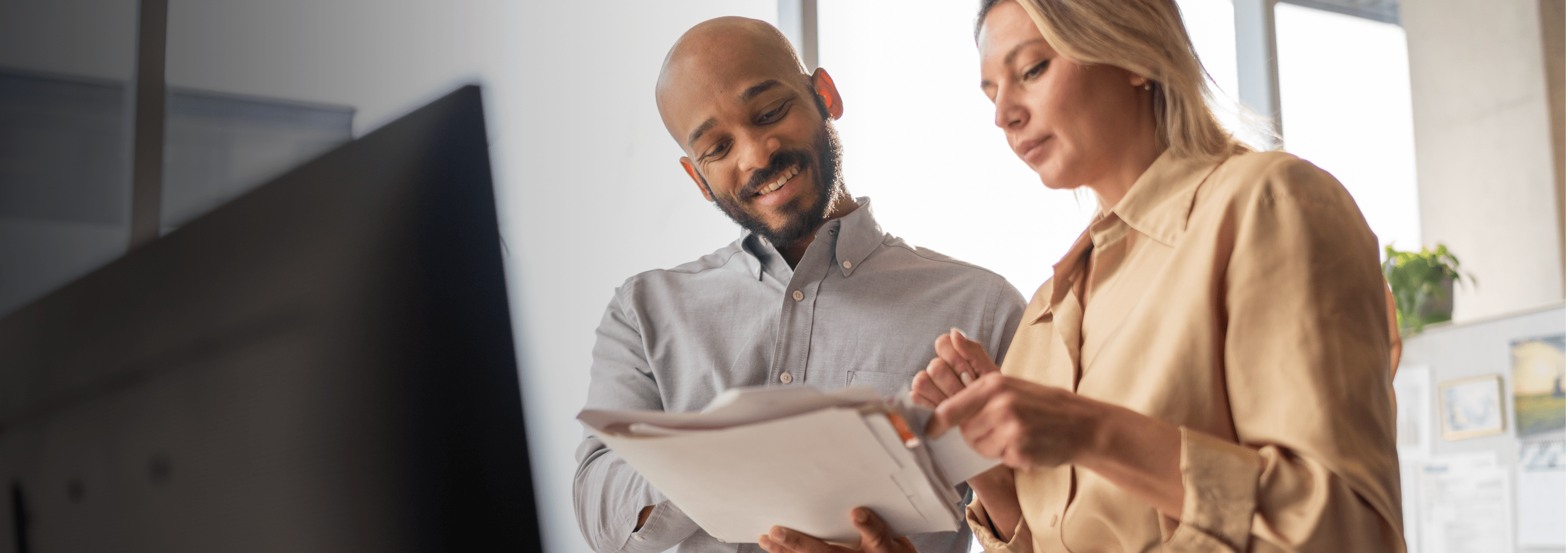 A man and woman reviewing documents together.